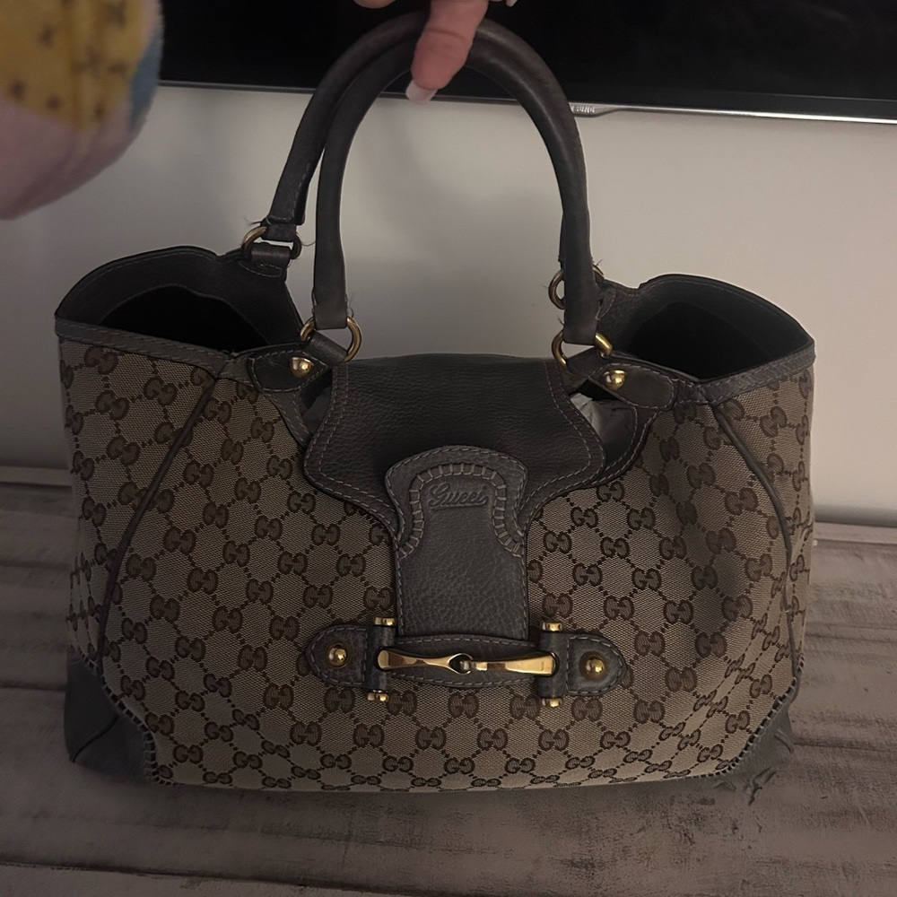 Gucci Tan iconic pattern with gray flap and gold hardware closure